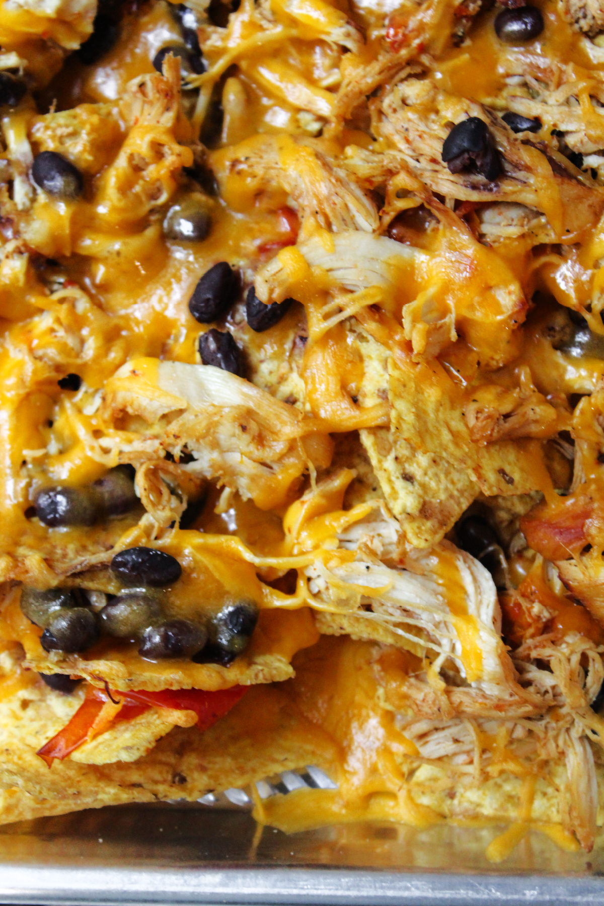 chicken fajitas nachos on a sheet pan.