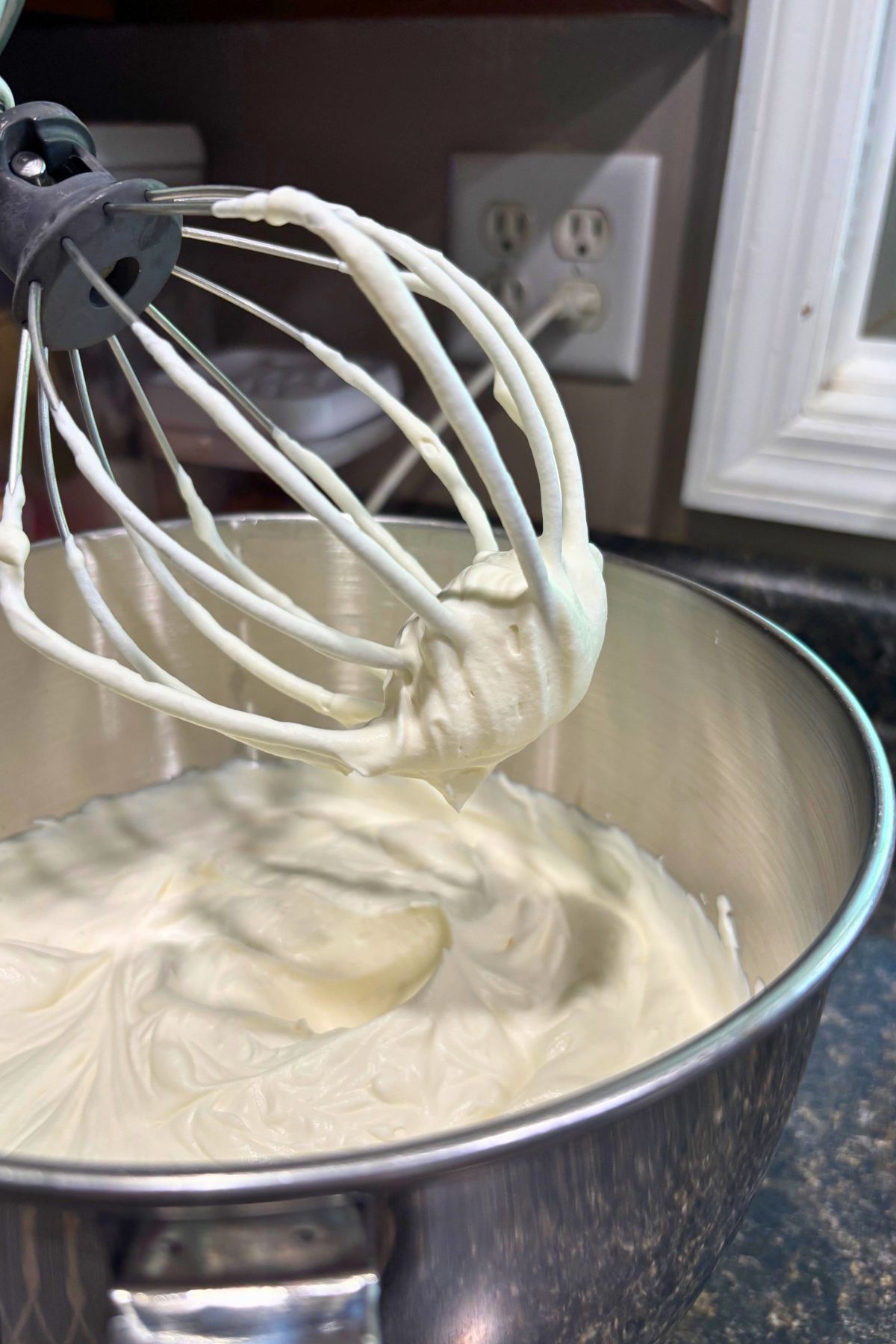 whipping cream being whipped in a bowl.