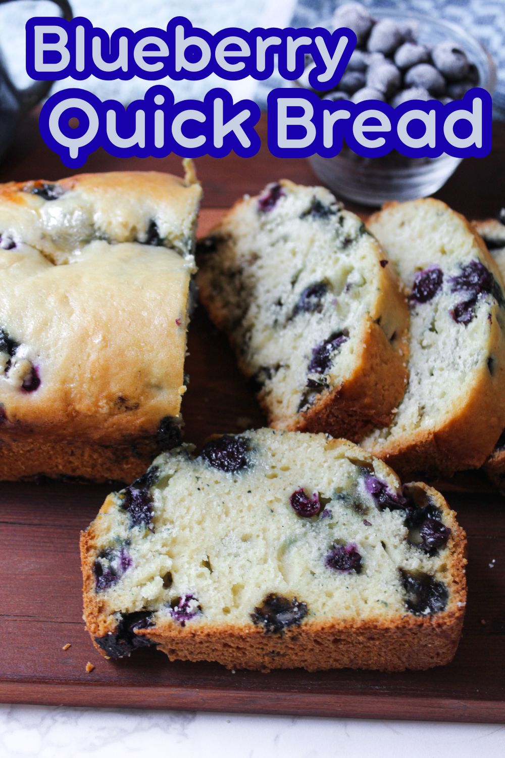 Blueberry Quick Bread slices on a brown board.