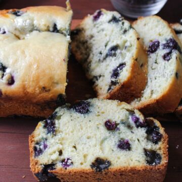 close up of blueberry quick bread on a brown tray.