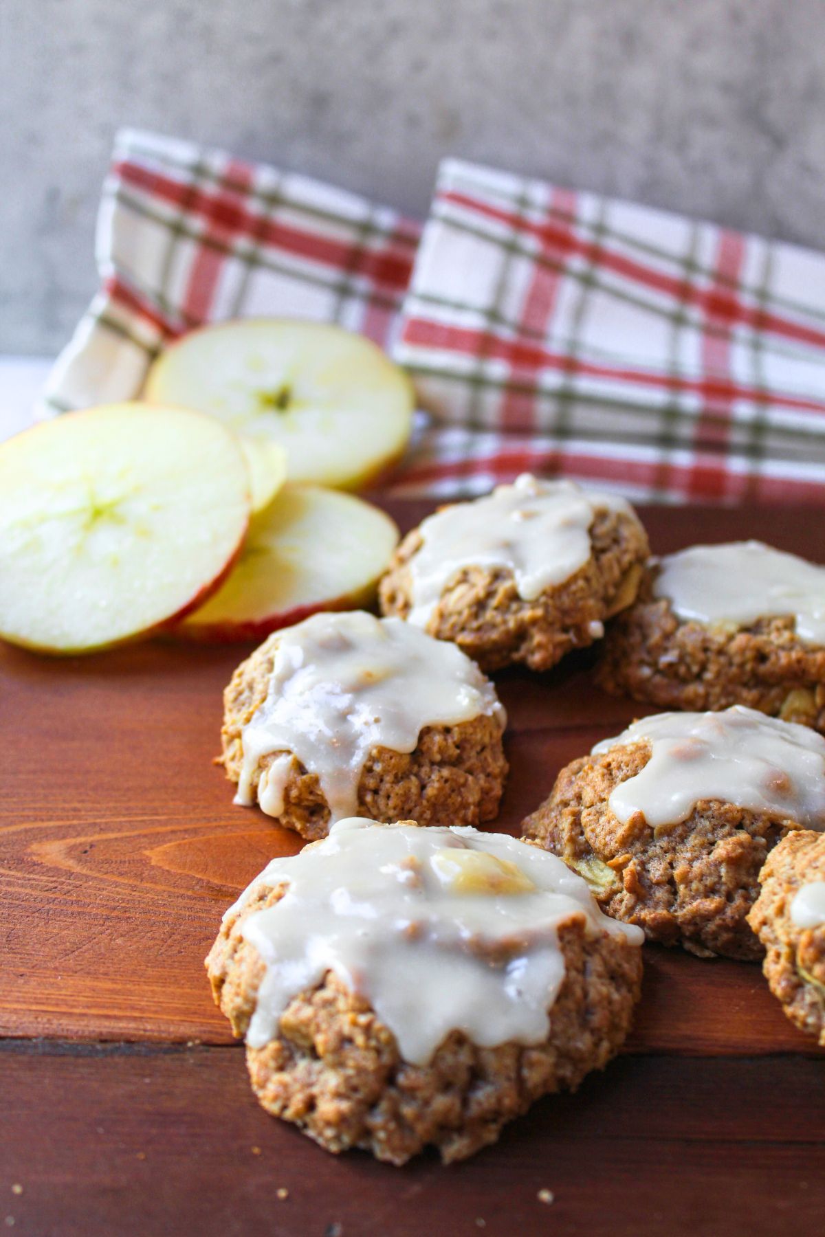 apple oatmeal cookies on a brown tray with apples nearby.